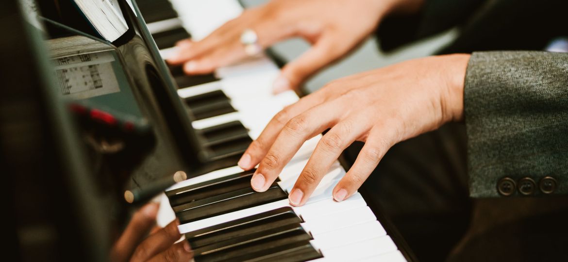 Man hands on grand piano for worship in Church.Male pianist Playing classic piano.Professional musician pianist hands on piano keys.